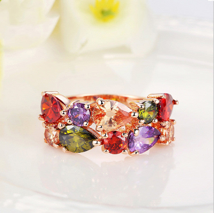 Colorful zircon ring with symmetrical AAA zircon stones in various hues, set on a polished 18k gold-plated copper band.