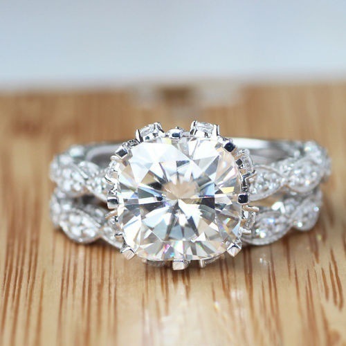 Jewellery Zircon Rings with a sparkling round zircon centerpiece and twisted electroplated alloy band on wood surface.