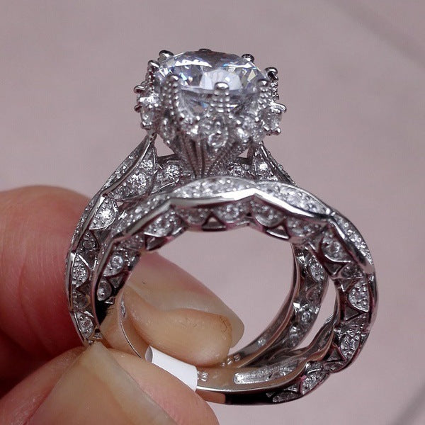 Zircon alloy ring set with electroplated finish, showcasing a raised solitaire zircon and detailed vine-style band.