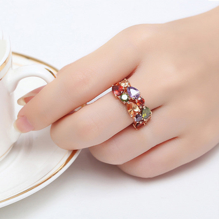 Colored zircon ring with multicolor AAA zircon gemstones on a woman's hand, featuring 18k gold-plated copper band for elegant style.
