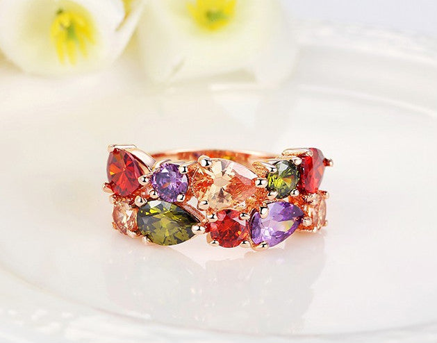 Colorful zircon ring with teardrop and marquise-cut AAA zircon stones in red, green, purple, and peach on 18k gold-plated copper band.