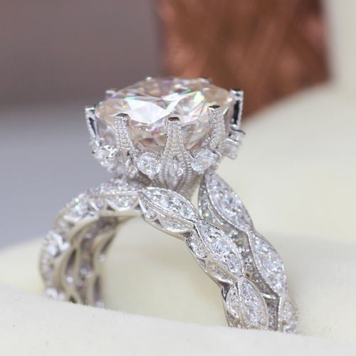 Jewellery zircon rings featuring electroplated alloy with a large round-cut zircon and intricate leaf-patterned band design.