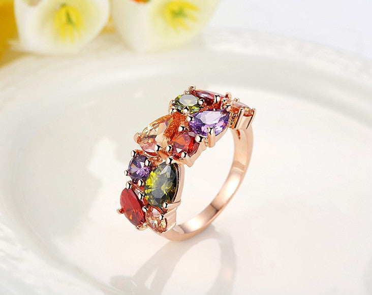 Stylish colored zircon ring with vibrant gemstone arrangement on a rose gold-plated copper band, ideal for fashion jewelry collections.